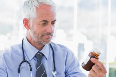 Doctor looking at medicine jar