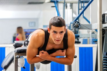 Man working his back on hyperextension bench