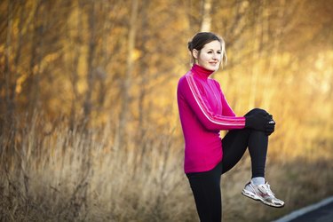 Young woman stretching before her run