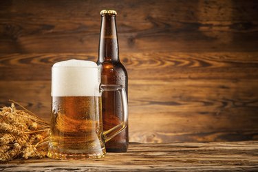 Glass and bottle of beer on wooden planks