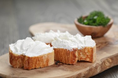 homemade appetizing crostini with soft cheese cream herbs