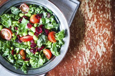 Kale and edamame salad on rustic background