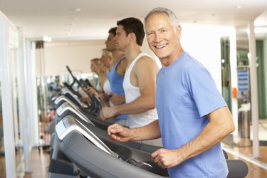 Senior Man On Running Machine In Gym