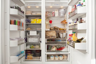 Stacked products in open fridge