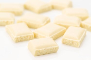 small pieces of white chocolate on white background