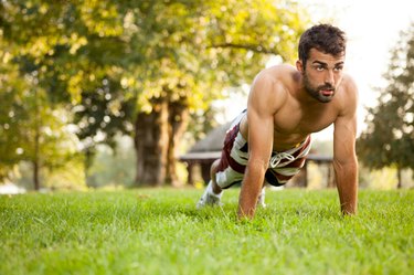 man doing push-ups in the park