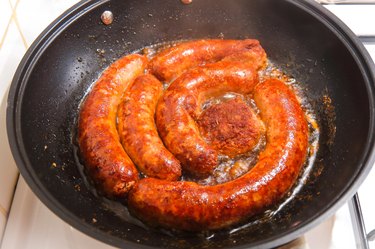 Close-up of sausages frying in a pan