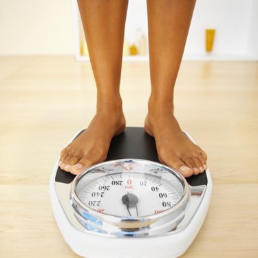 Close-up of a woman standing on a weighing scales