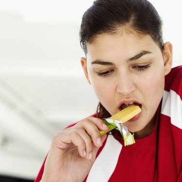 Close-up of a young woman eating candy