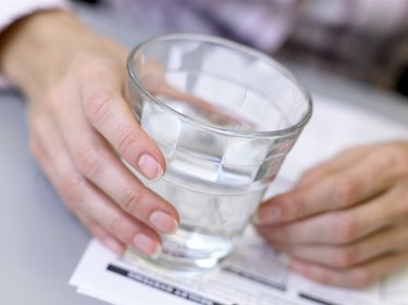 Businesswoman holding glass of water