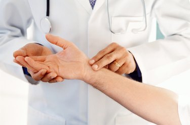 doctor checking a patients pulse