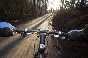 Person driving mountain bike (blurred motion)