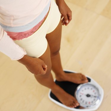Close-up of a woman standing on a weighing scales