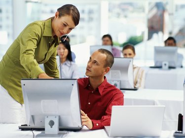 businesswoman training a businessman at a seminar