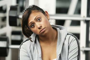 Portrait of a young woman sitting in a gym