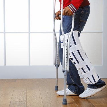 Man using crutches and leg brace