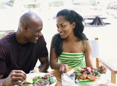 Side view of a young couple eating