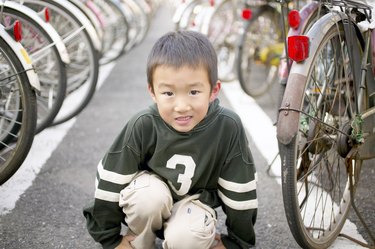 Smiling boy by bicycles