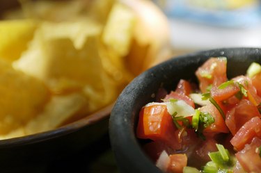 Bowl of salsa and tortilla chips at Mexican Restaurant
