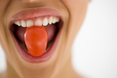 Woman eating a tomato