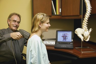 Doctor examining patients back