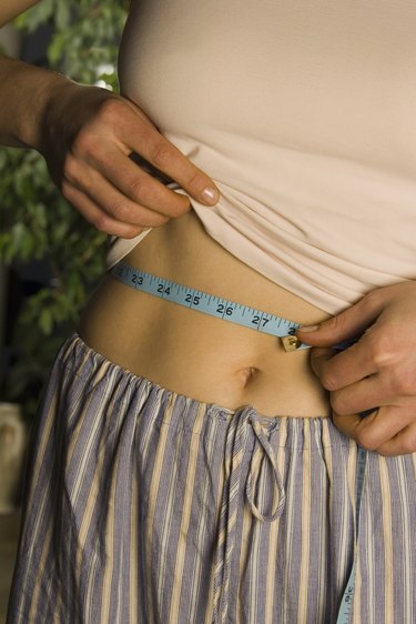 Woman measuring waist