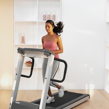 Woman running on a treadmill at home