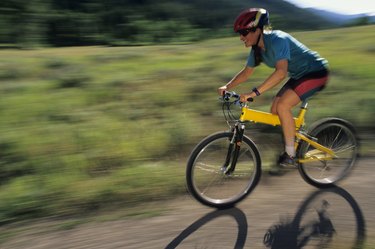 Female mountain biker riding on trail in park