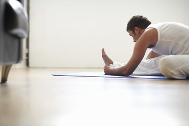 Man sitting in janu sirsasana position