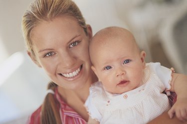 Portrait of a Young Mother Holding Her Newborn Baby
