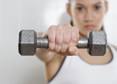 Young woman holding a dumbbell