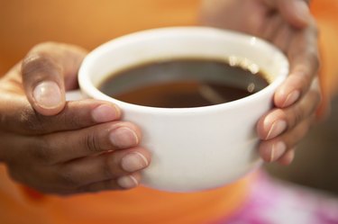 Hands holding cup of coffee