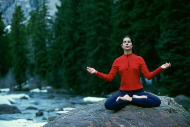 Young woman meditating in the lotus position