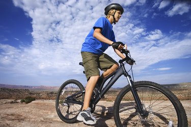 Teenage boy riding bicycle