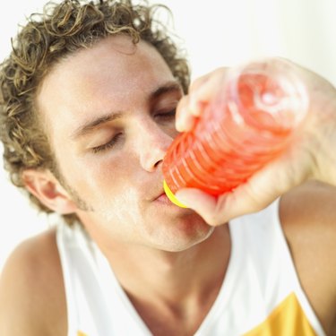 Elevated view of a man drinking juice from a bottle