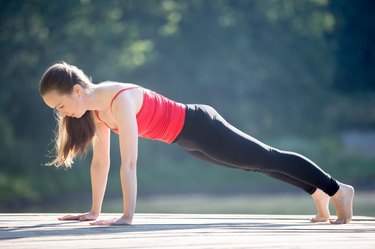 Beautiful Young Sports Lady Doing Push Ups While Workout At Home