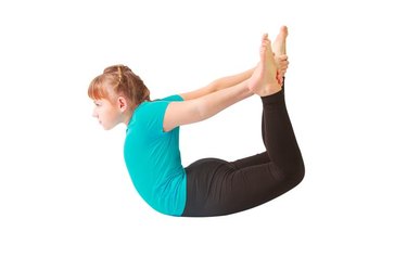 beautiful flexible woman doing yoguna white background