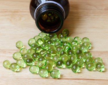 Supplement food,Vitamin E capsule on wooden table.