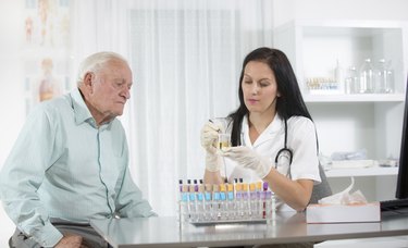 Doctor passes urine cups to patients