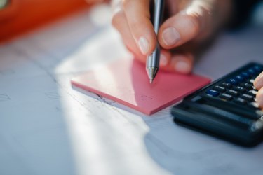 Woman hand, calculator and ball pen