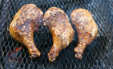 Chicken legs grilling  on a barbecue