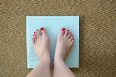 Woman weighing herself