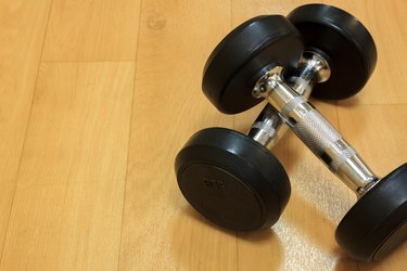 Dumbbells on the wood background.