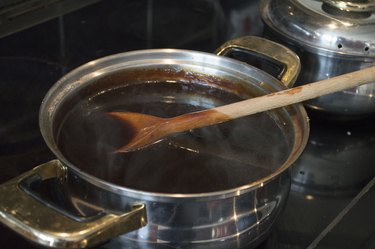 Silver pan of gravy boiling on the stove