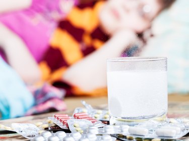 drug dissolves in water and pill on table close up