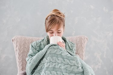Attractive woman with cup of hot drink