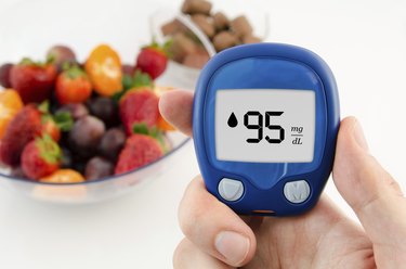 Hand holding meter. Diabetes doing glucose level test.