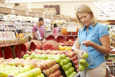 Woman At Fruit Counter In Supermarket