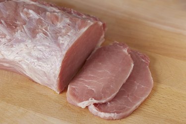 Cutting raw pork loin