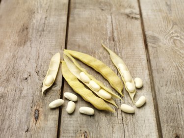 Still life of cannellini beans (also known as white kidney beans) on wooden table